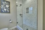 Master bathroom with a double vanity and a large tile shower with glass doors